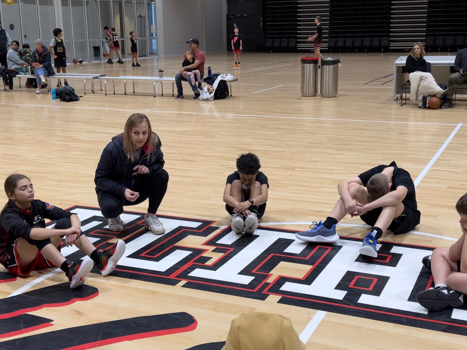Sophie coaching young athletes courtside
